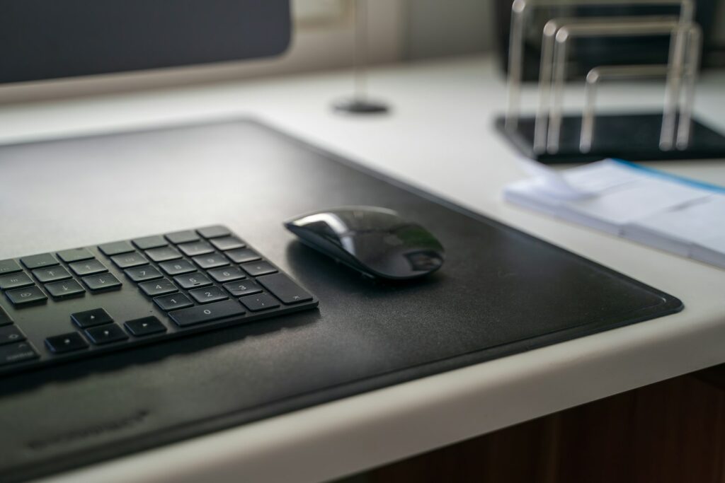black cordless computer mouse on black mouse pad